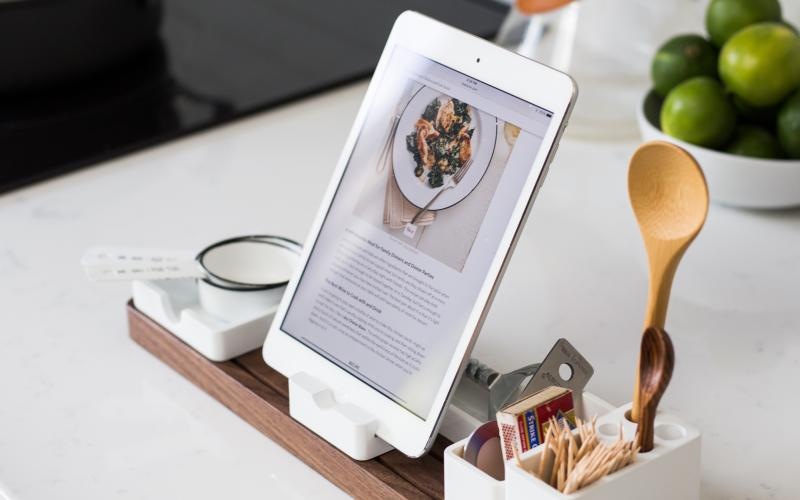 a tablet and a spoon on a table