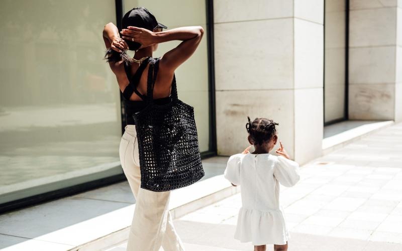 a woman walking with her child