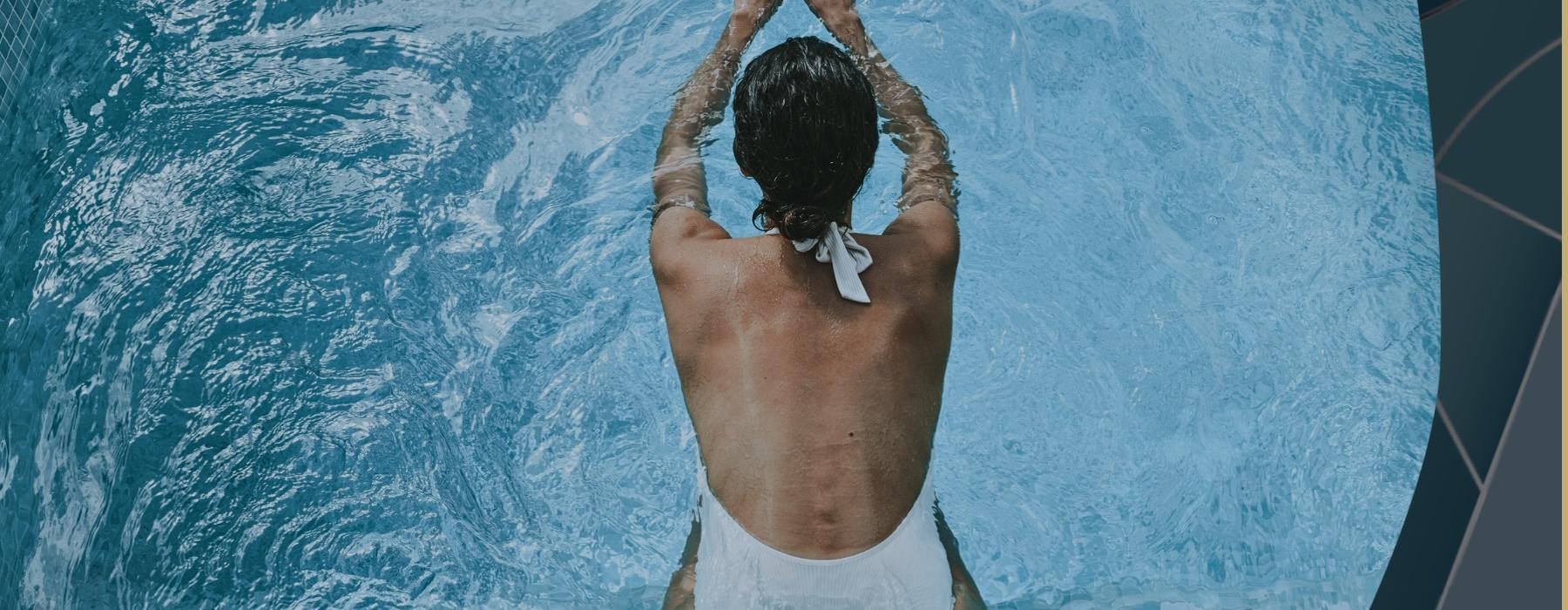 a man standing in front of a pool